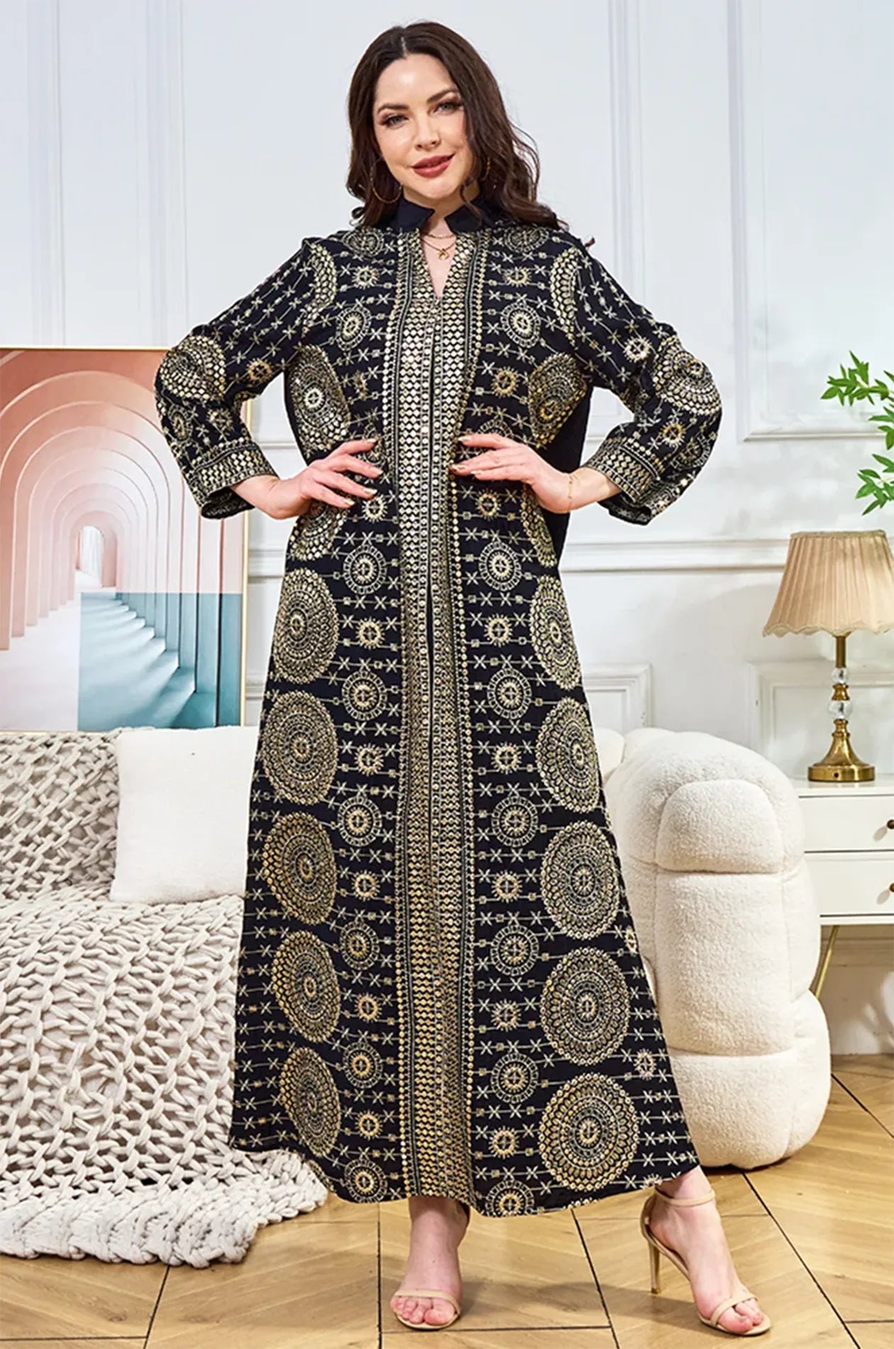 Model posing in the Aluna black mirror kaftan, showcasing the luxurious reflective patterns in a lifestyle setting.