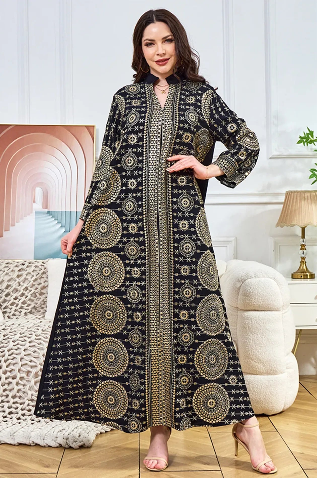 Model displaying the wide flare and fluid motion of the Aluna black mirror kaftan, ideal for evening parties.