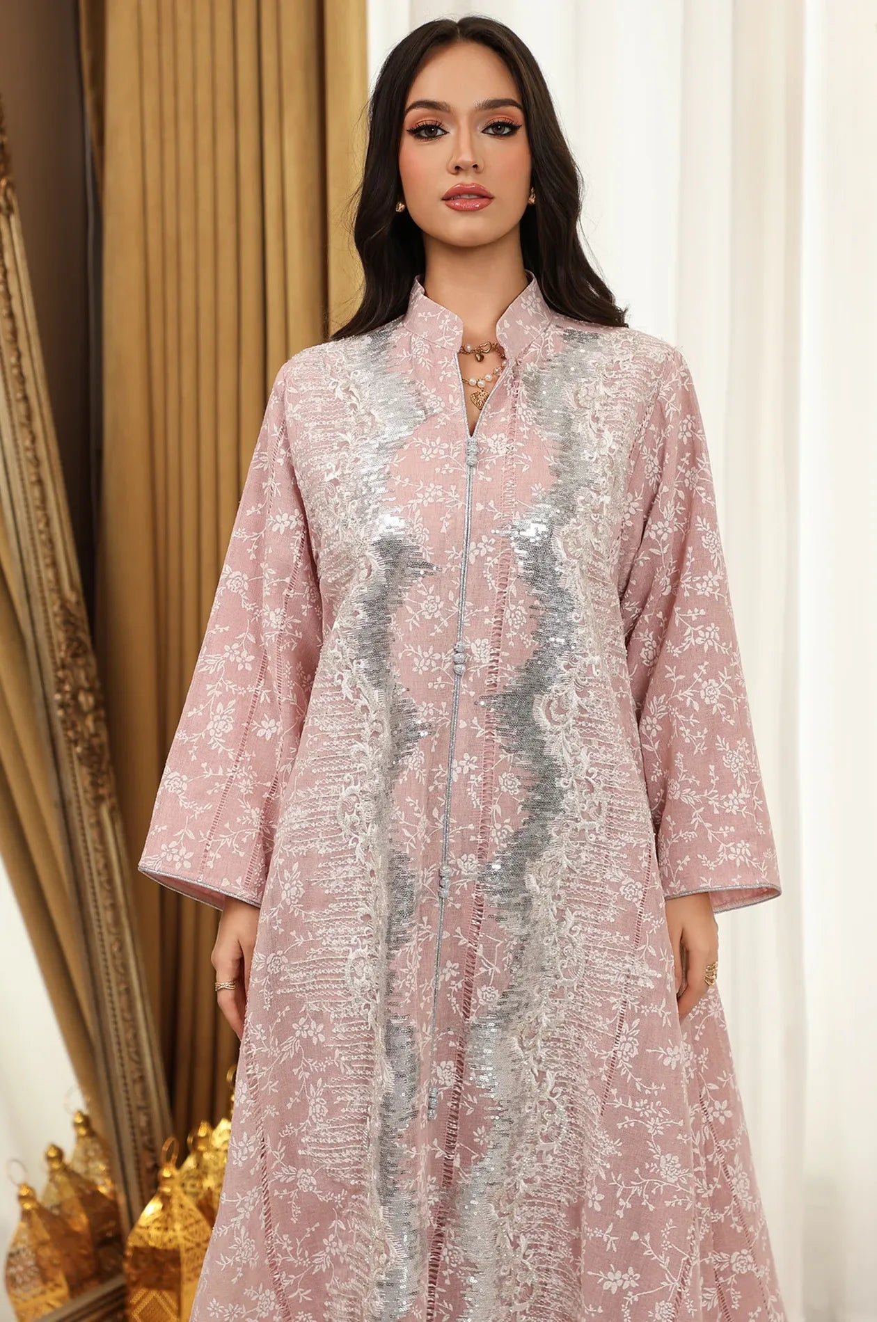 Close-up of the bodice and button detailing on the pink Alura shimmer kaftan from Naylaraβs embellished collection.