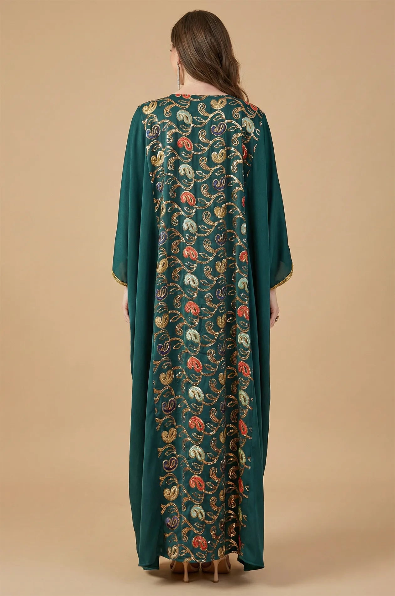 Rear view of the green Amiri kaftan showing the intricate vertical sequin paisley panel on the back.