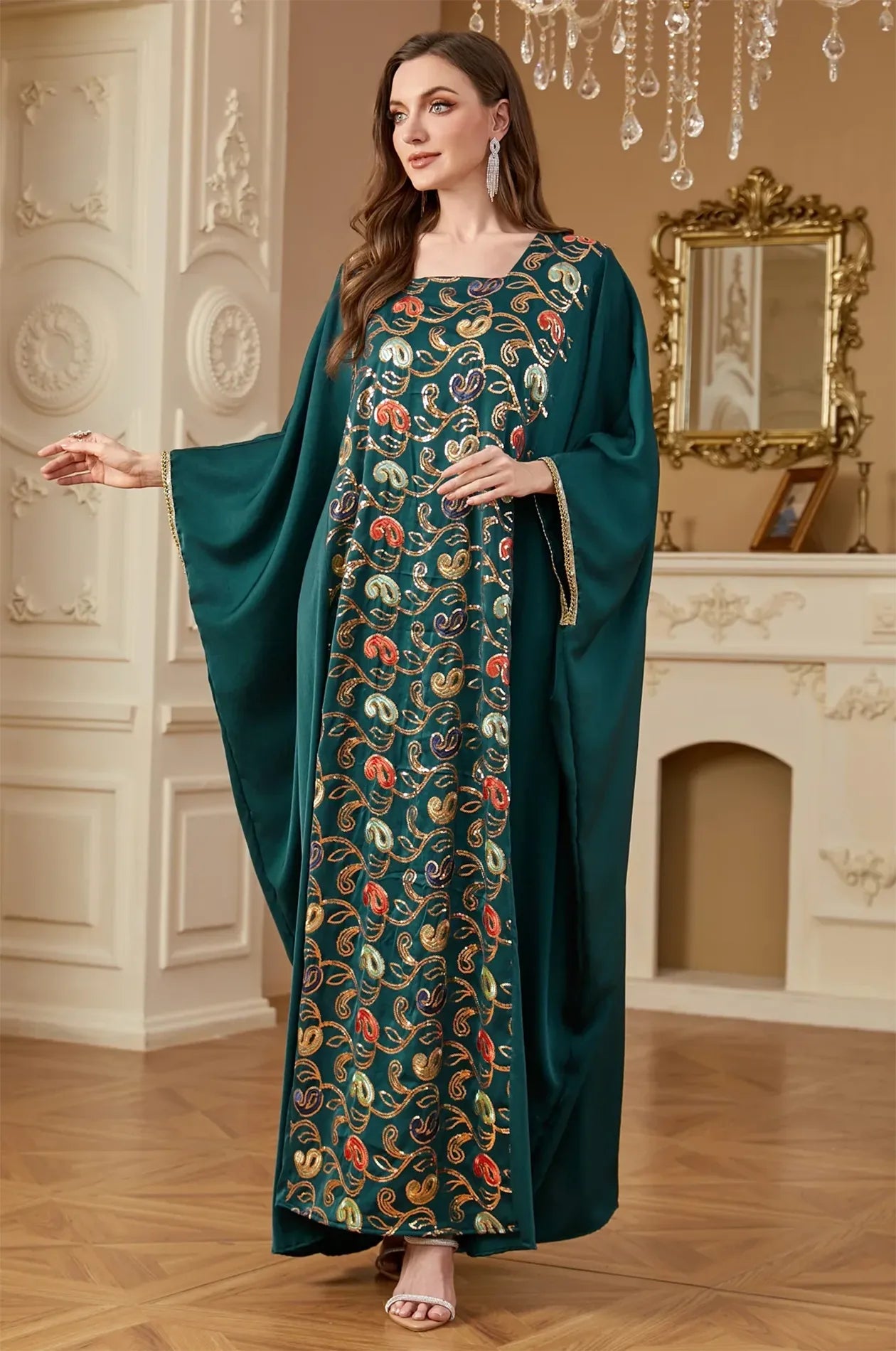 A dynamic shot of the emerald green Amiri kaftan dress from Naylara, perfect for evening parties.