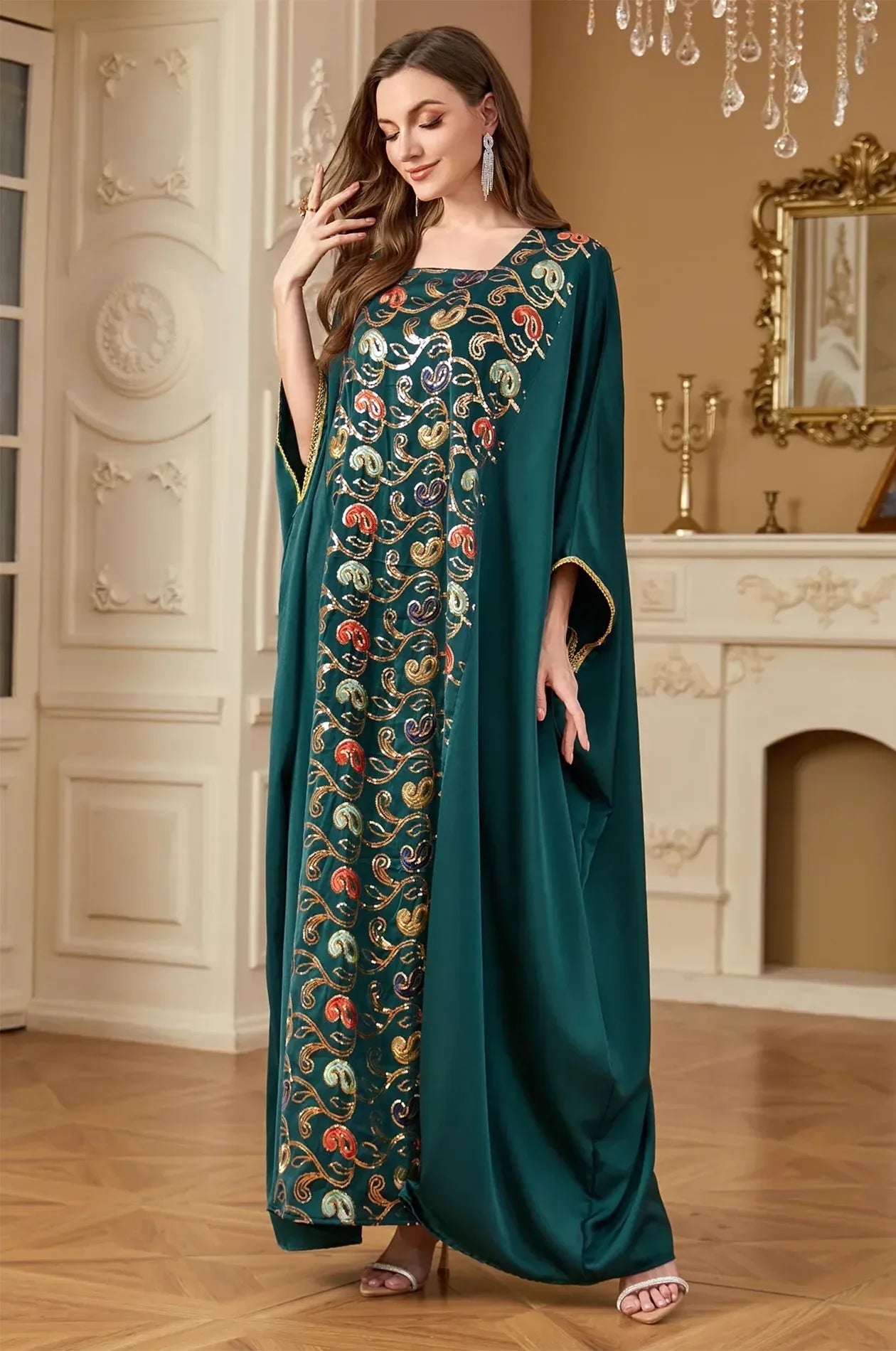 3/4 view of the green Amiri Farasha kaftan featuring artisanal sequin patterns and a modest silhouette.