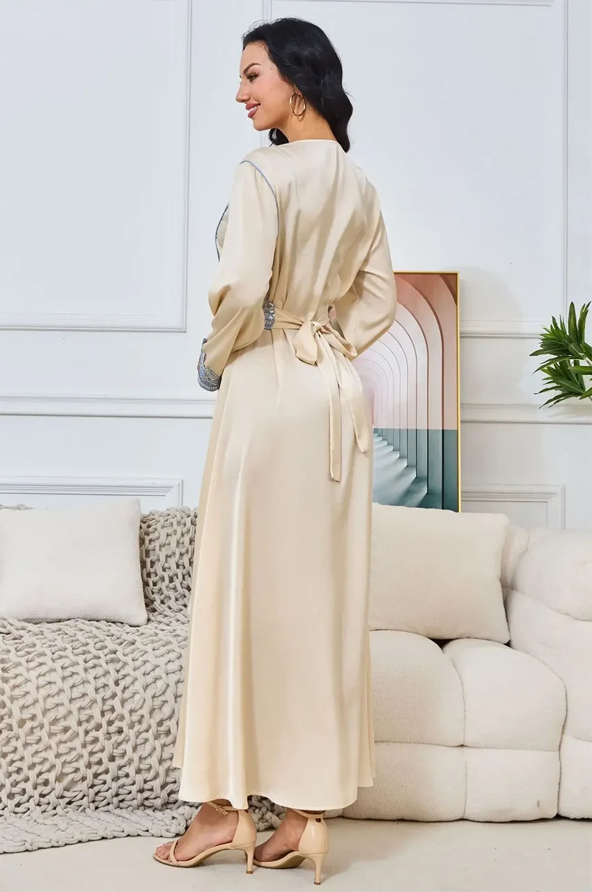 Wide-angle flare of the Ayana long satin kaftan skirt and hemline.