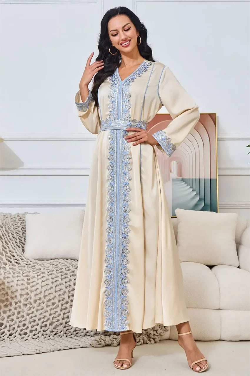 Fashion pose featuring the Ayana long satin kaftan with silver hoops.