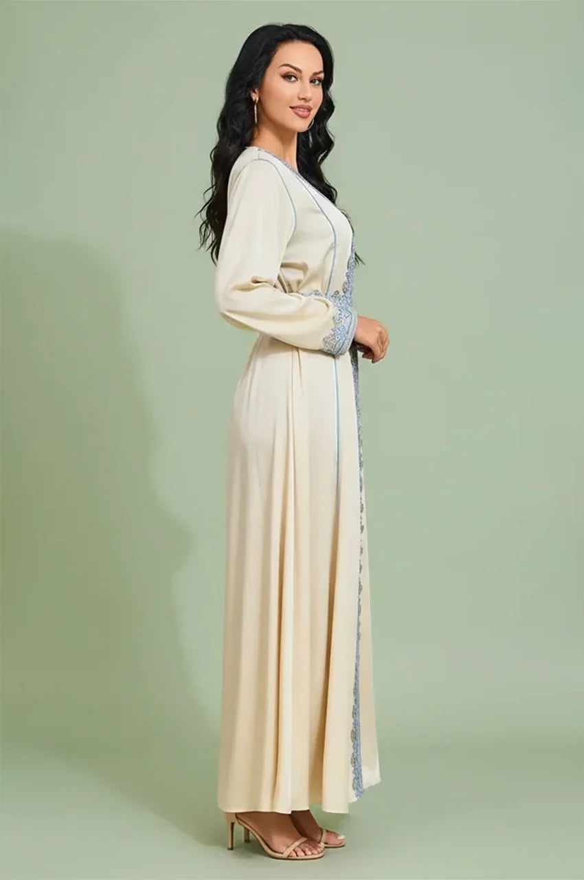 Side profile of the Ayana long satin kaftan in high-luster cream fabric.