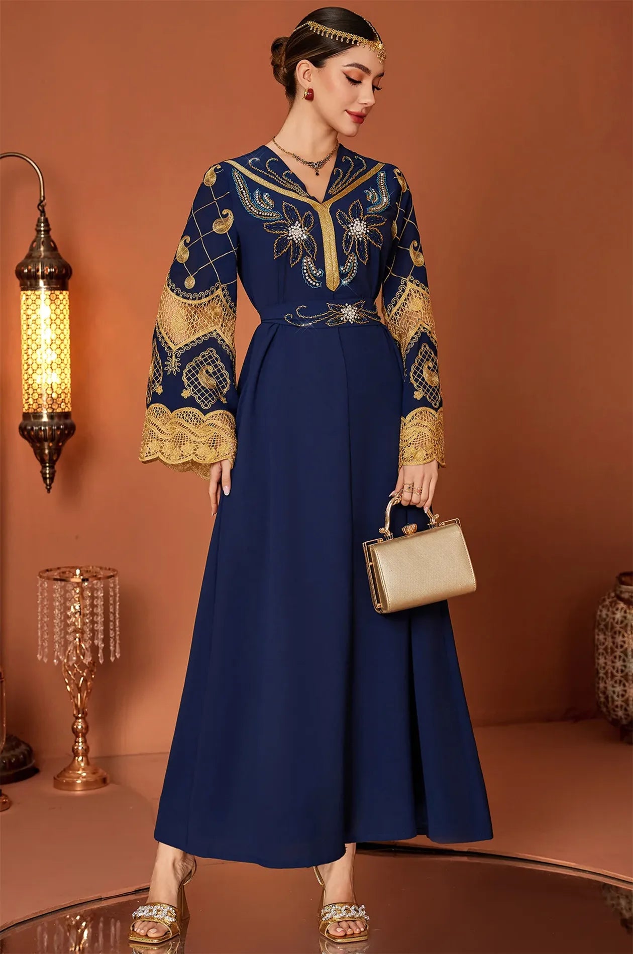 Full-length shot of the Aysel kaftan in a studio setting with traditional lanterns.