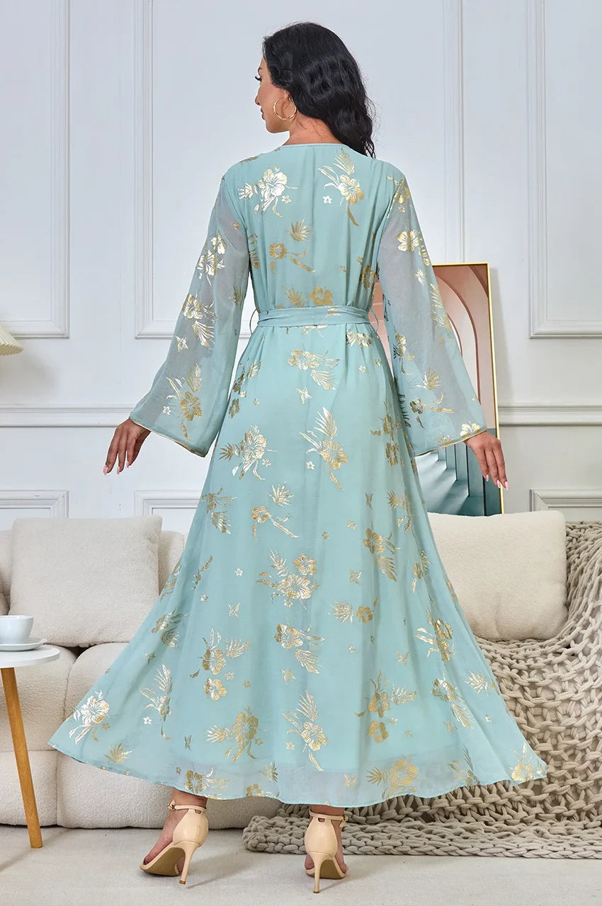 Back view of the Malika Aqua kaftan showing the shimmering gold foil floral print and flowing chiffon fabric.