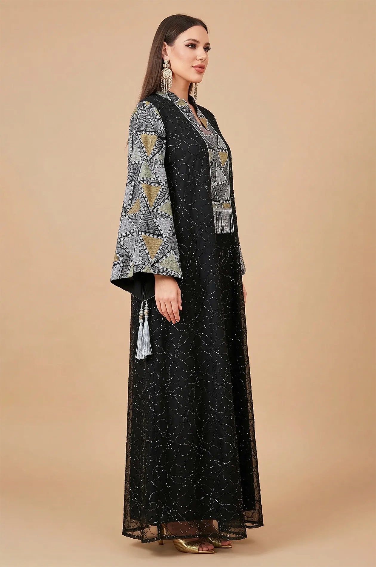 Side profile of the Black Kaliera geometric kaftan showcasing the fluid drape and sophisticated flared bell sleeves.