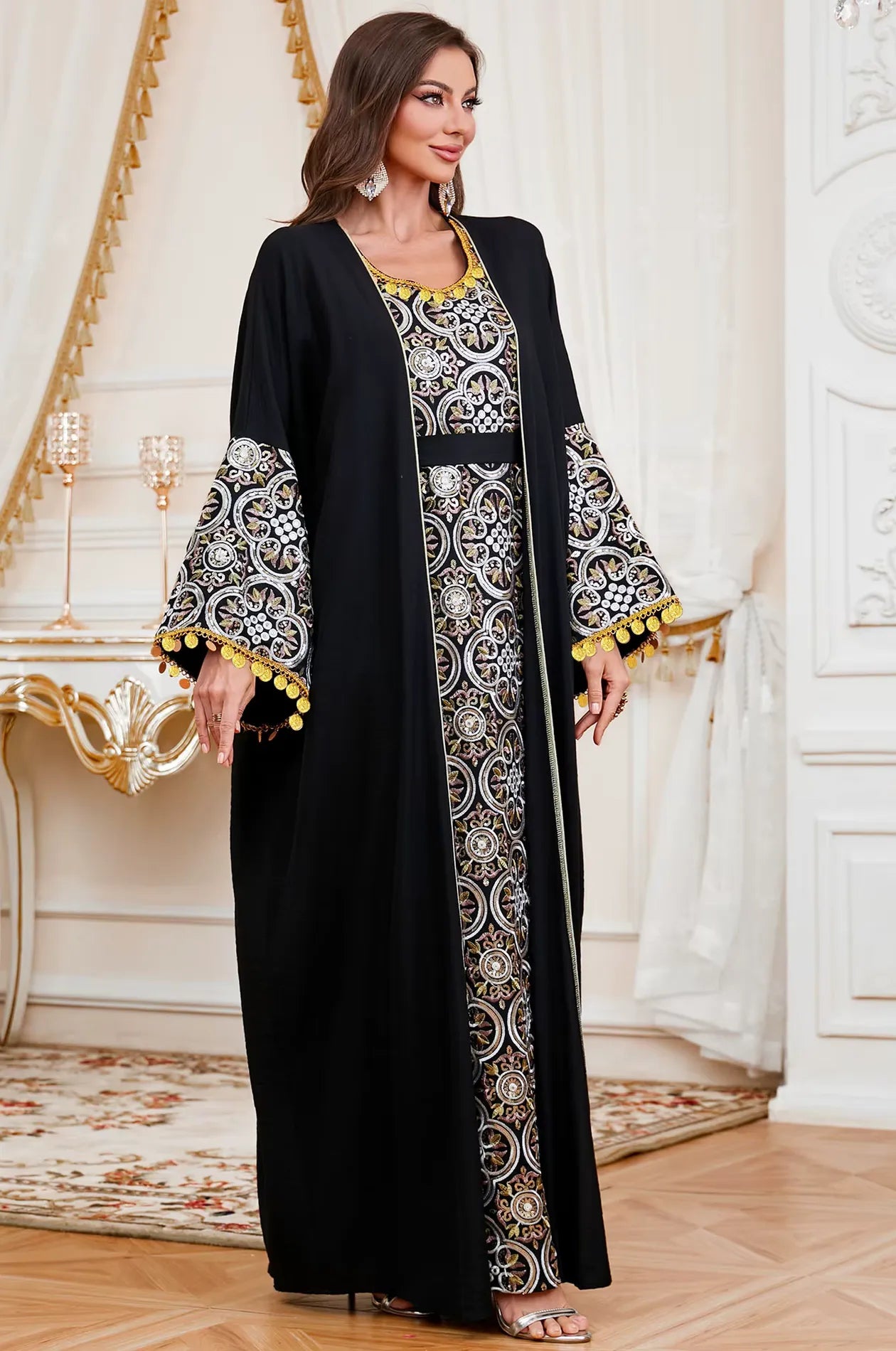 Full front lifestyle view of the Black Novae crepe kaftan by Naylara featuring gold medallion embroidery and bell sleeves.