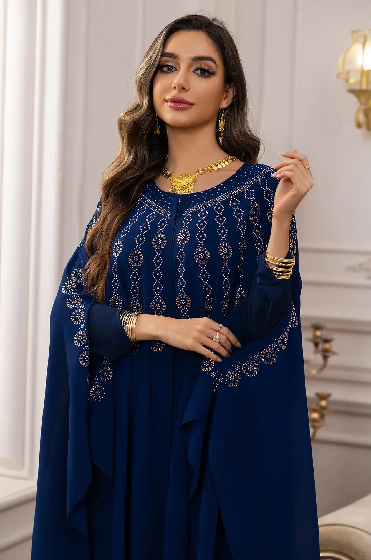 Close-up of the embellished neckline and gold accessories paired with the Navy Blue Cassia Kaftan.