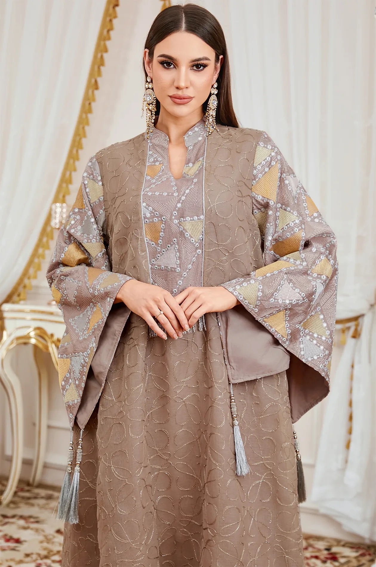 Close-up detail of the Brown Kaliera kaftan's silver tassel fringe and intricate geometric embroidery on the chest and sleeves.