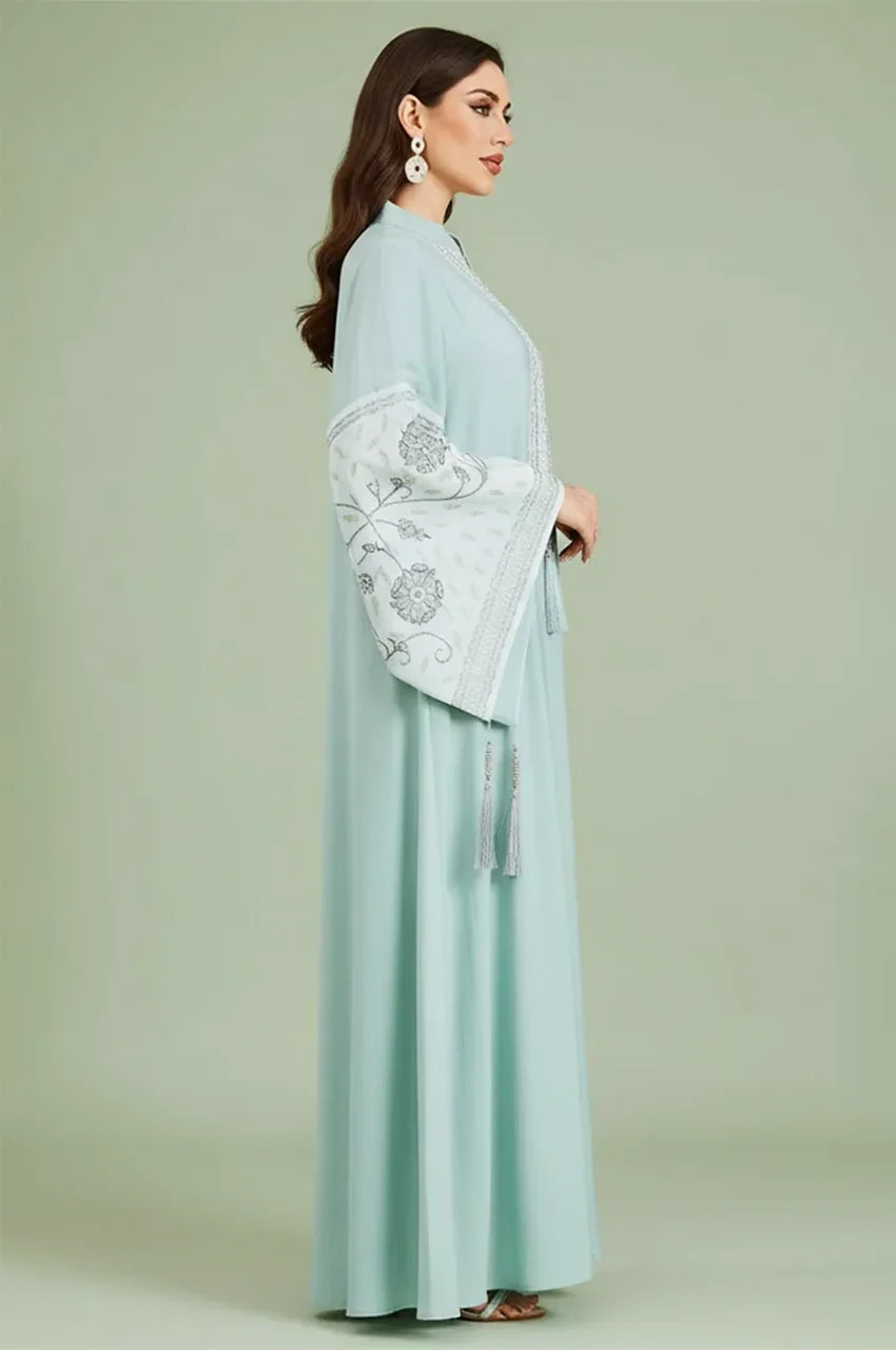 Side profile view of the Cyan Nairi cotton kaftan maxi, demonstrating the modest fit and dramatic bell sleeve design