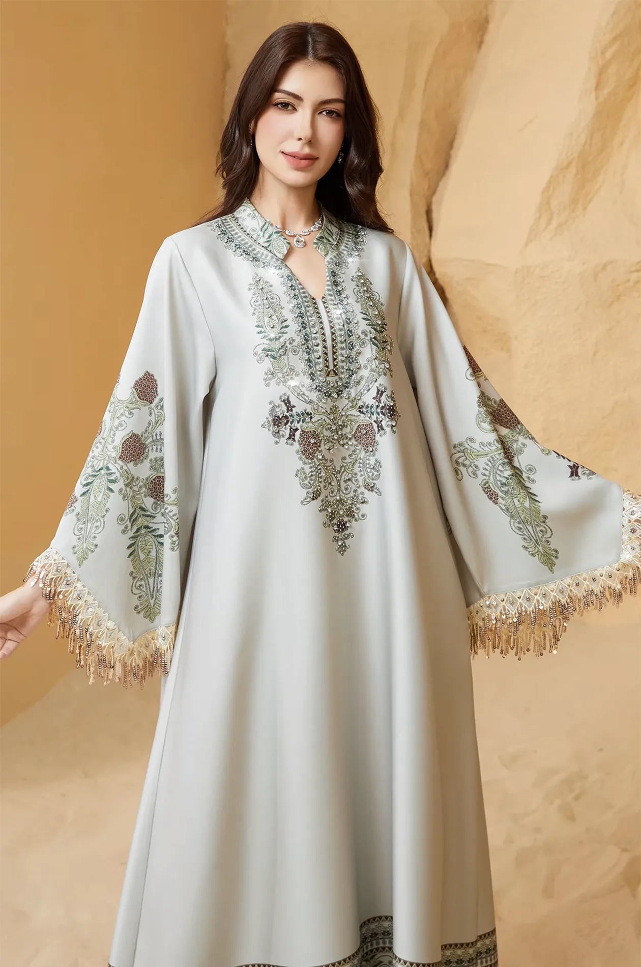 Close-up of the rhinestone and floral embroidery on the Eliah off white kaftan.