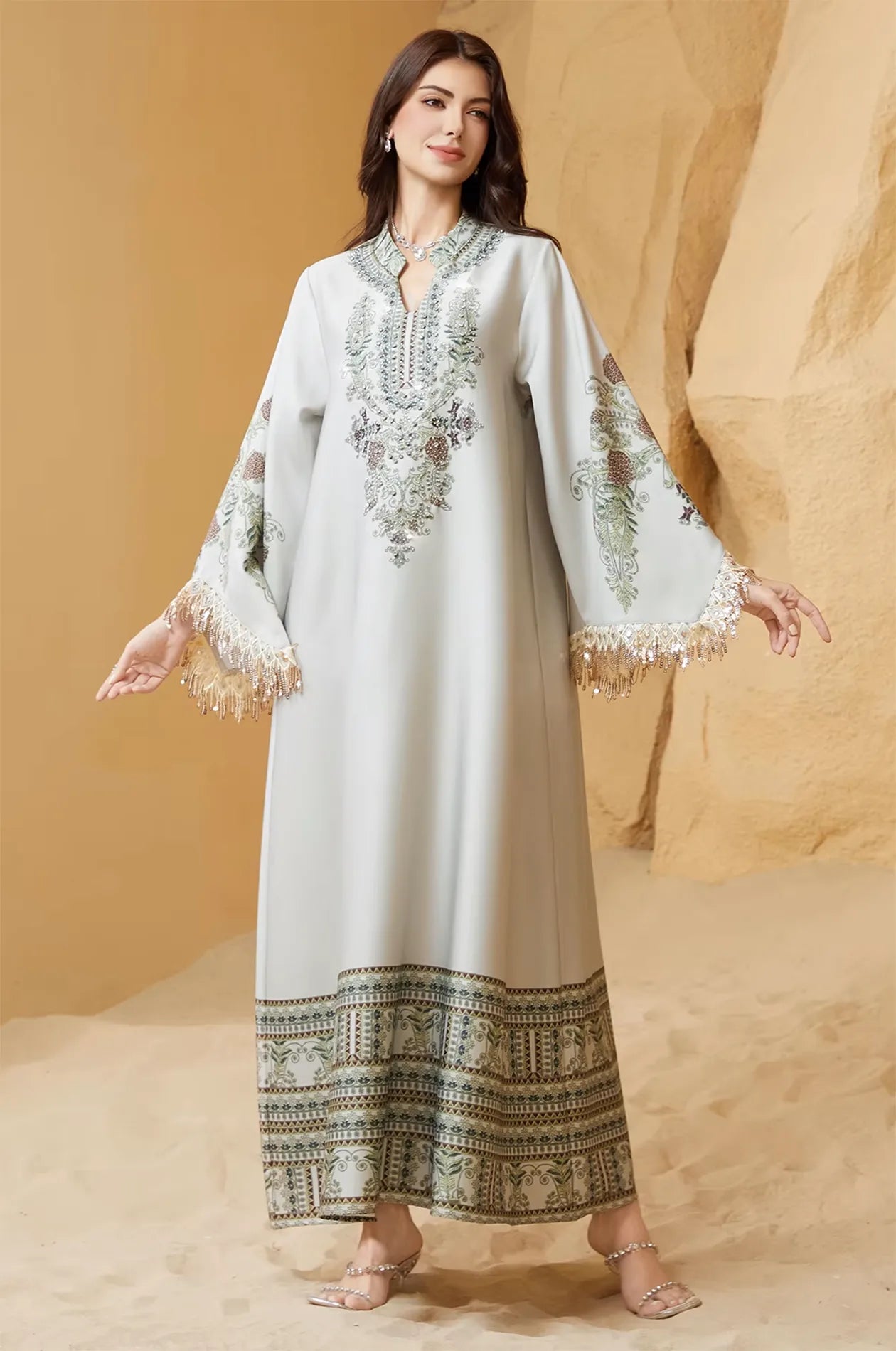 Dynamic shot of the Eliah kaftan showing the movement of the tassel cuffs.