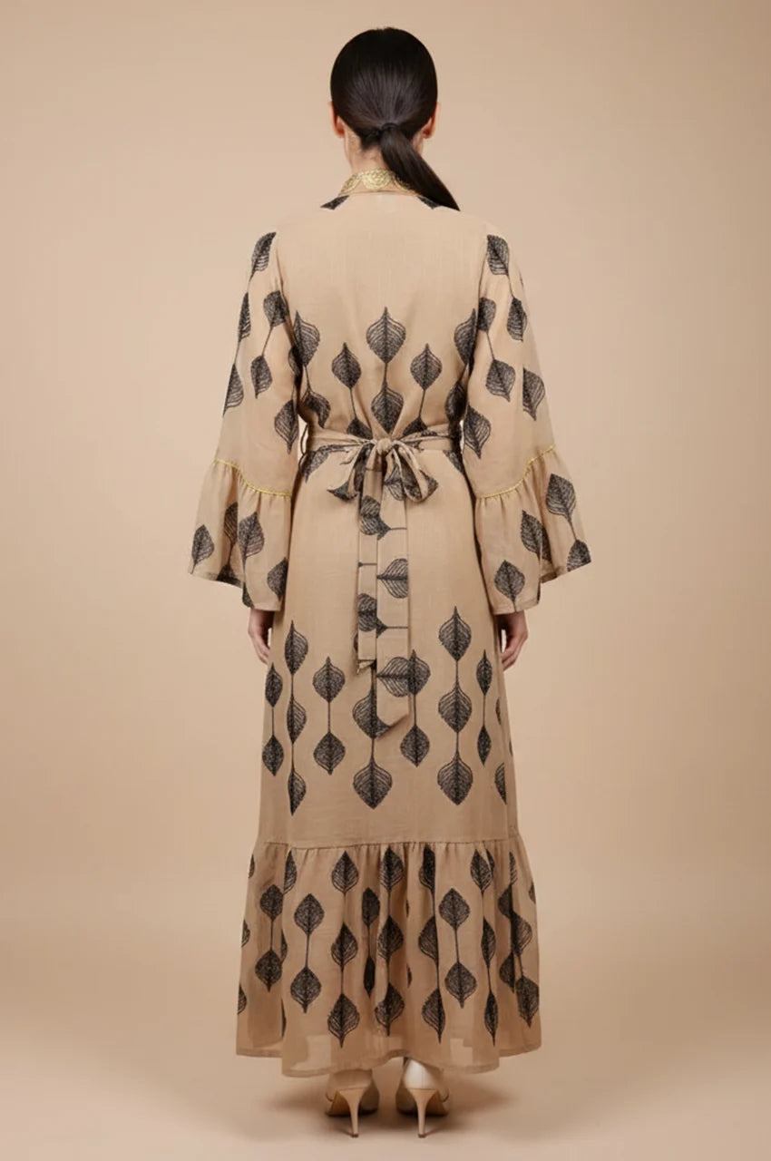 Back view of the floor-length khaki kaftan showcasing the fluid A-line drape and sheer mesh.