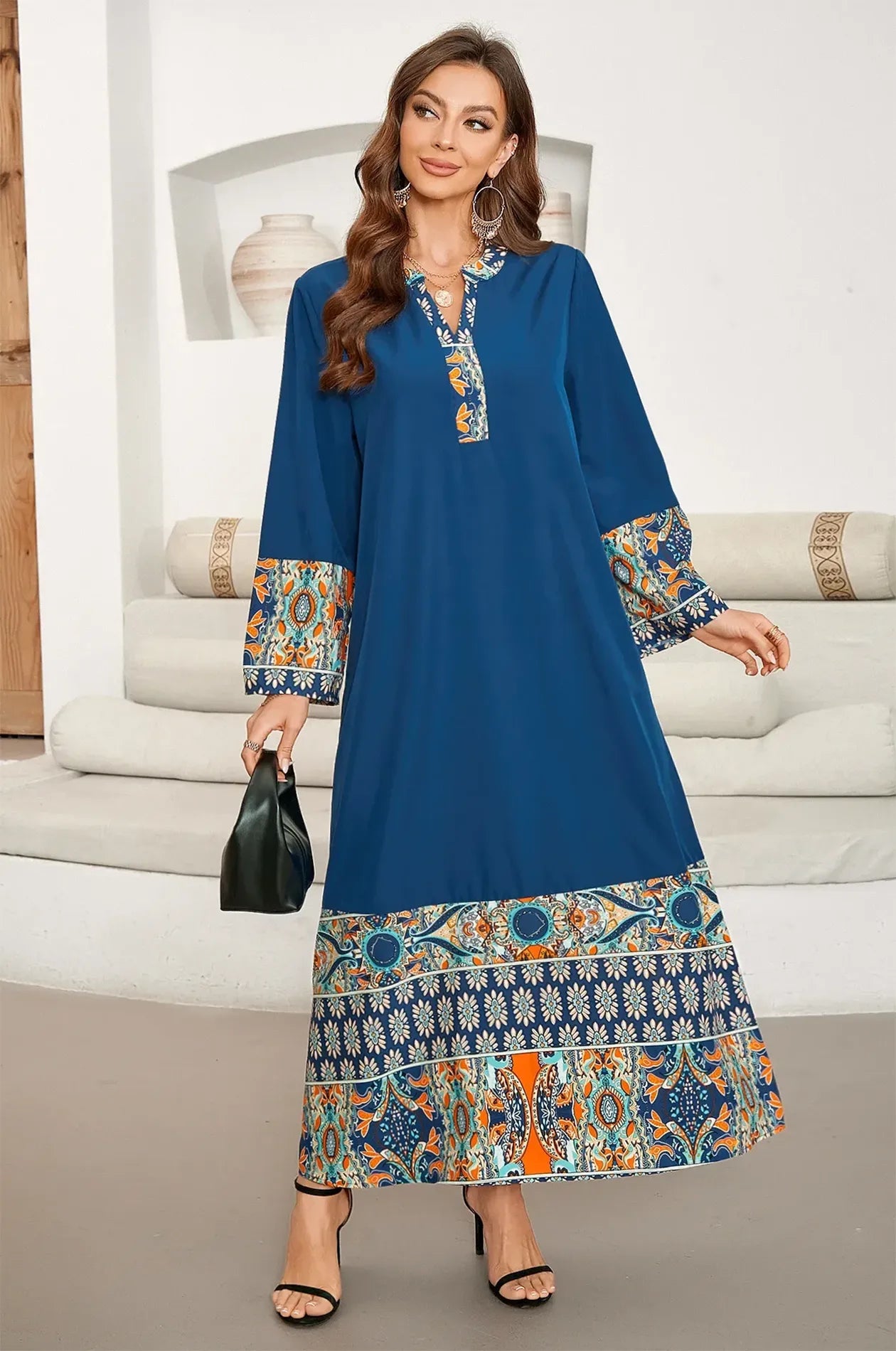 Elyah indigo kaftan styled with a black handbag for a modern chic look