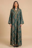 Full-length front view of the Estel dark green jacquard kaftan with gold floral patterns on a neutral beige studio background.