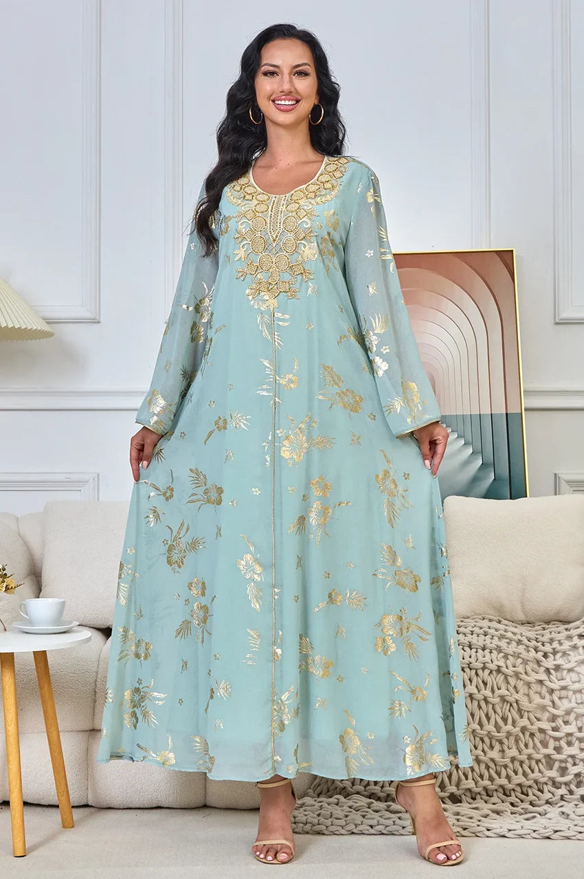 Full length view of the Malika Aqua Gold kaftan showing the width and movement of the sheer chiffon overlay.