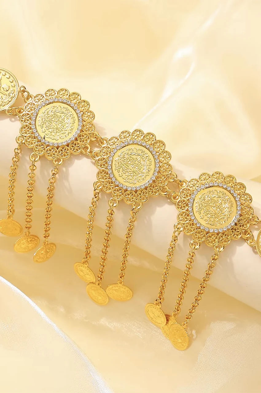 Close-up of the cascading gold chains and coin charms hanging from the belt.