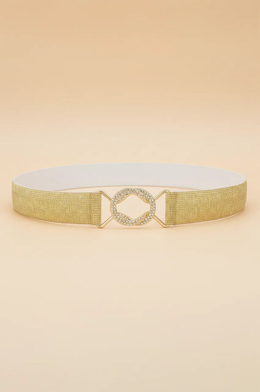 Front view of the gold metallic elastic waist belt with crystal buckle on beige background.