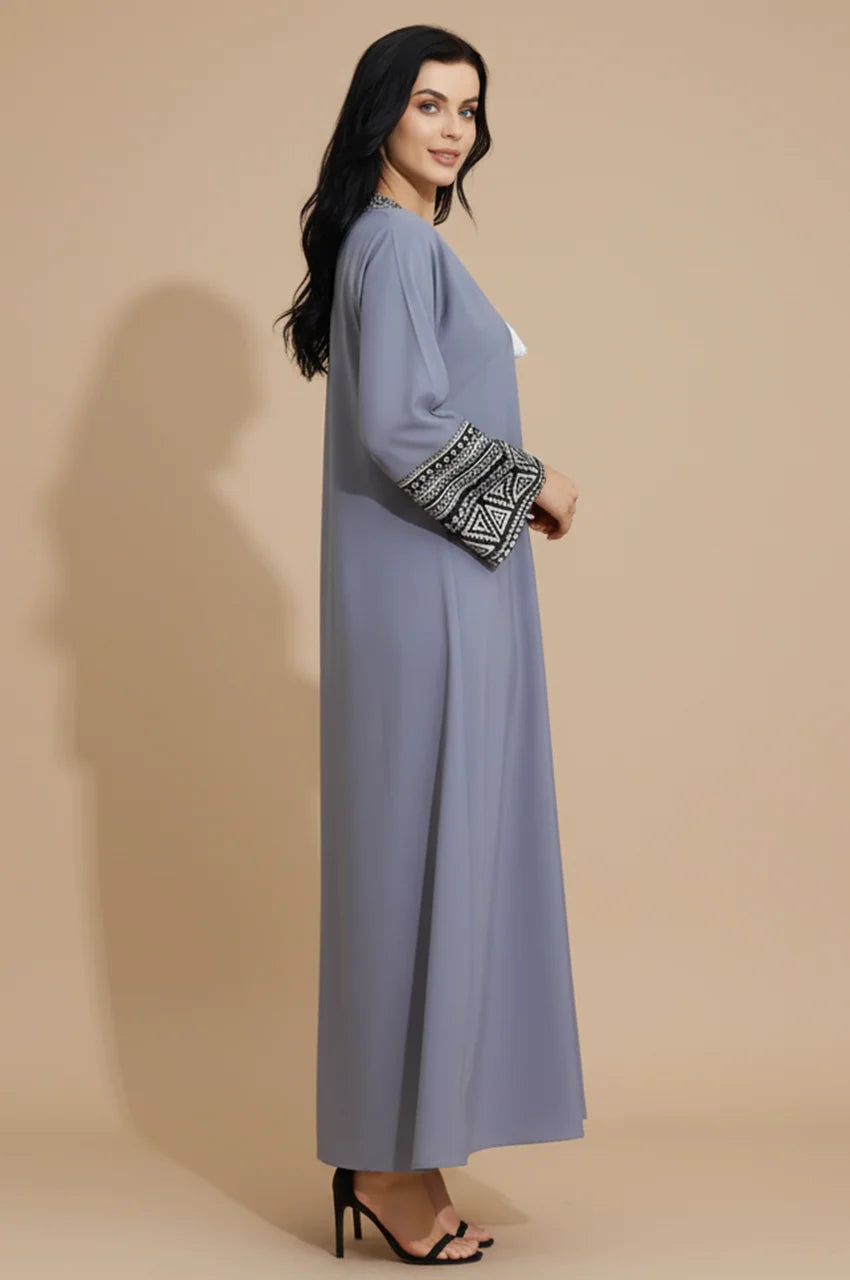 Side profile of woman wearing Keyla gray kaftan showing sleeve embroidery.