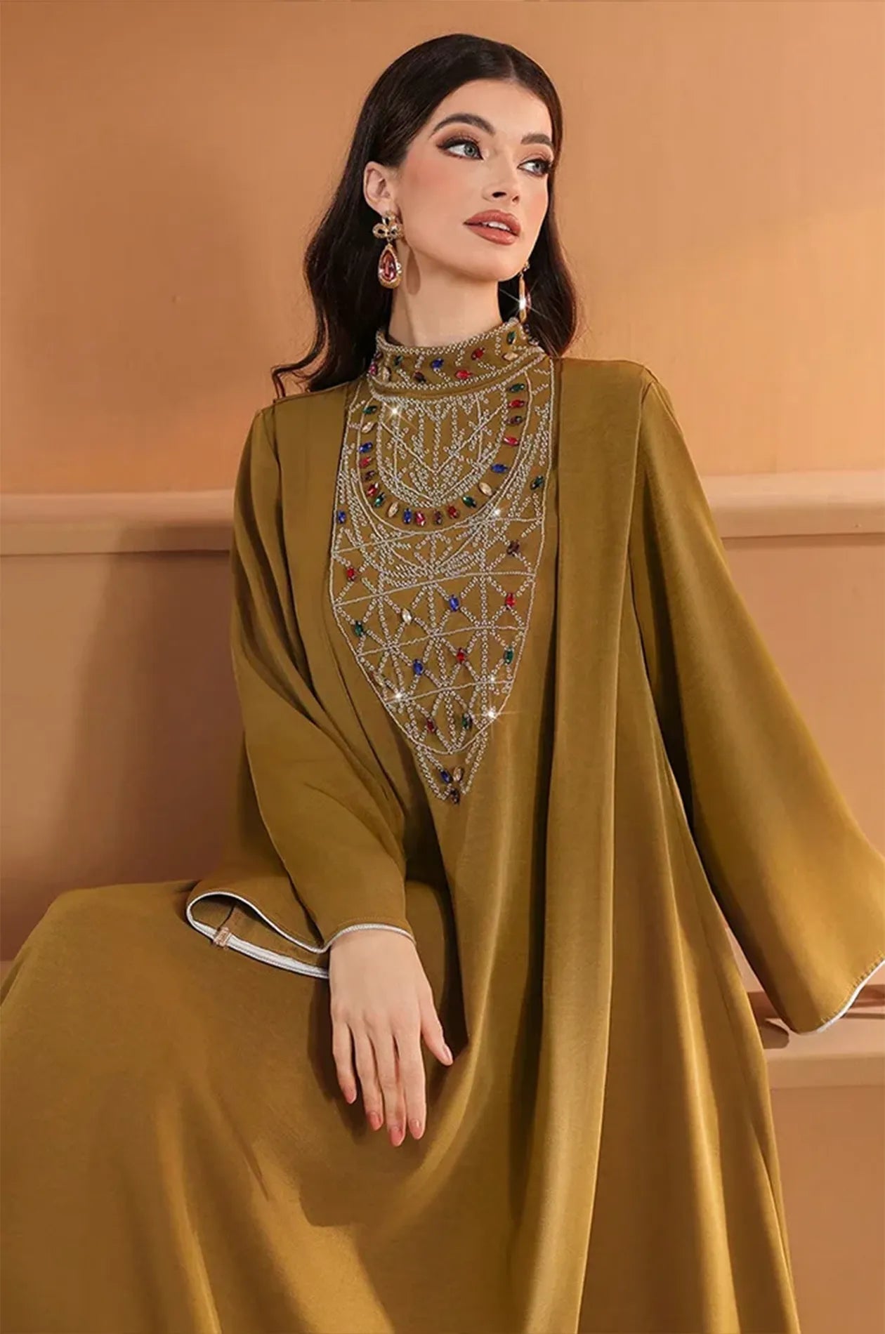 Close-up of the jeweled mock neck and upper embroidery of the Rami design.