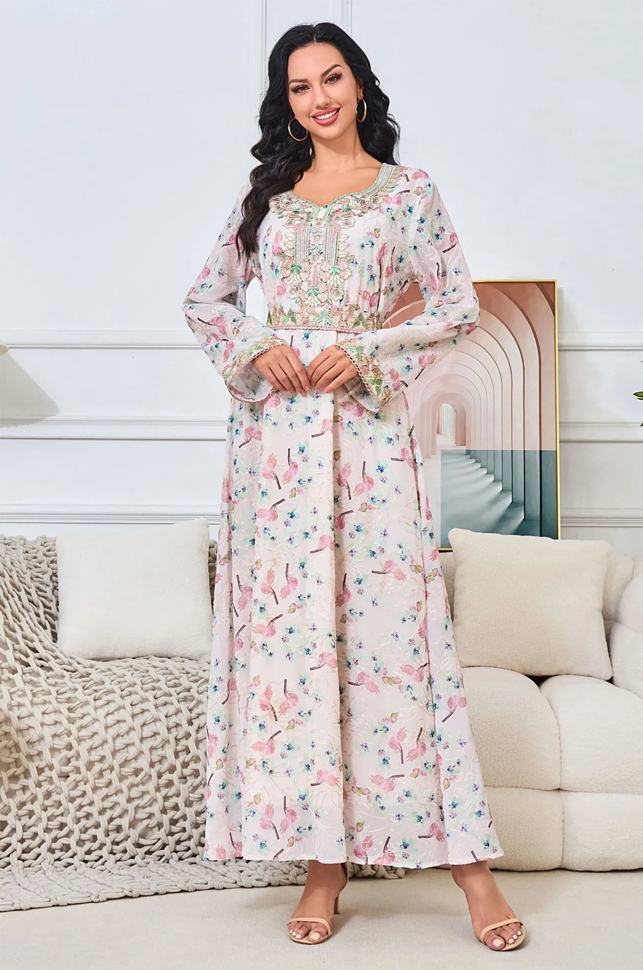 Fashion model wearing the Ilani blush pink kaftan in a bright interior setting.