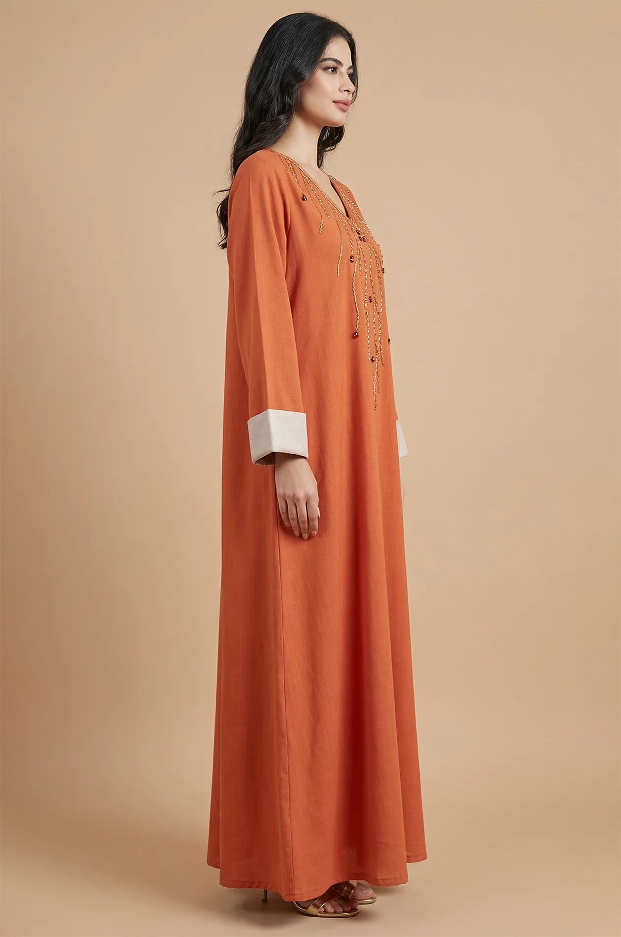 Side profile of the Ilena kaftan highlighting the sleeve length and cream cuffs.