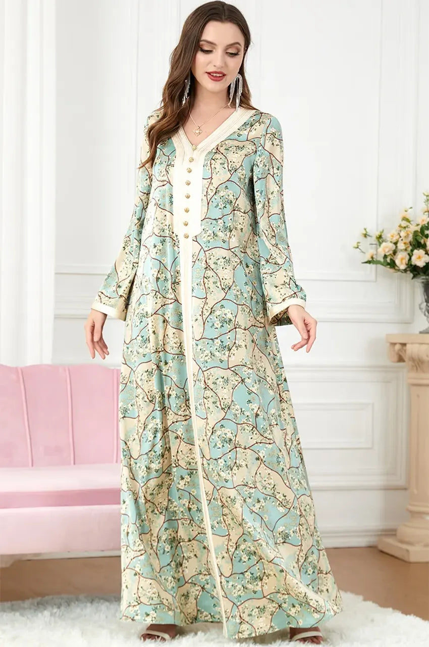 Standing view of the Isara green casual Moroccan kaftan maxi dress with floral motifs and traditional braided ivory trim.