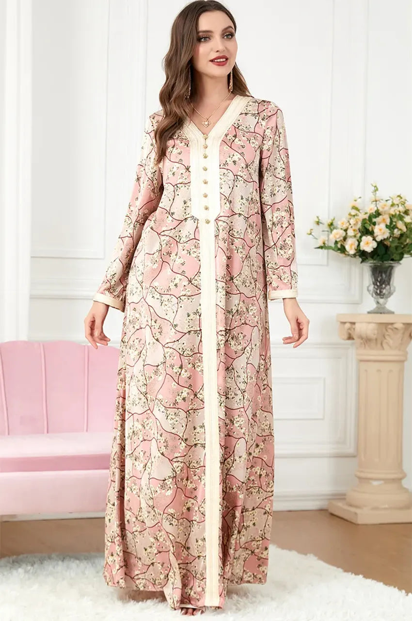 The Isara pink casual Moroccan kaftan shown in a standing pose, showcasing the soft fabric drape and elegant silhouette