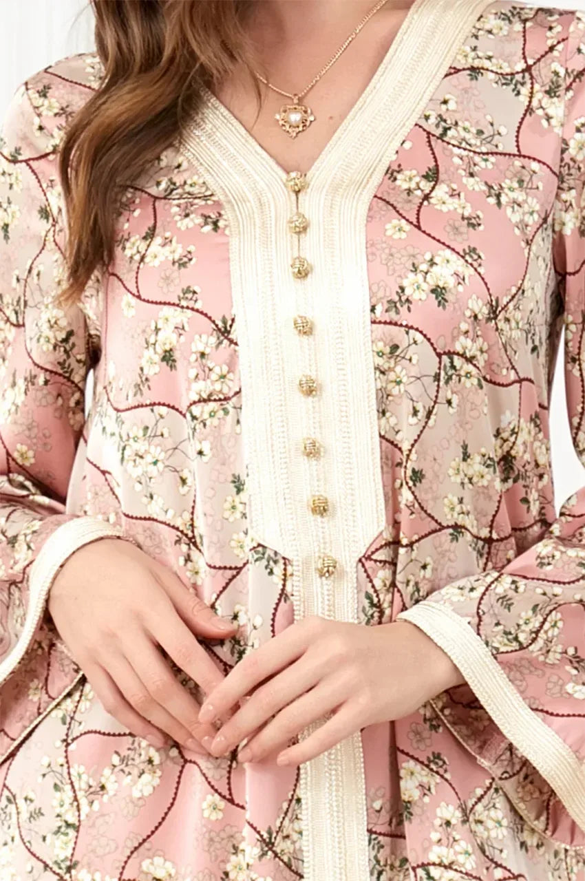 Close-up detail of the traditional handmade Aakad buttons and ivory Sfifa trim on the Isara pink kaftan.