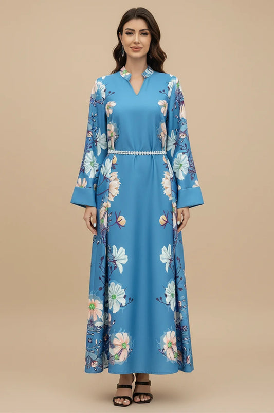 Front view of Janel sky blue kaftan with floral print and pearl belt standing.