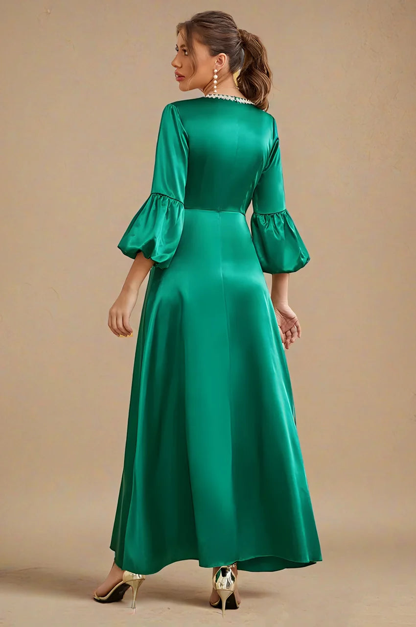 Kiara emerald green kaftan back angled view with puff sleeves and elegant satin drape