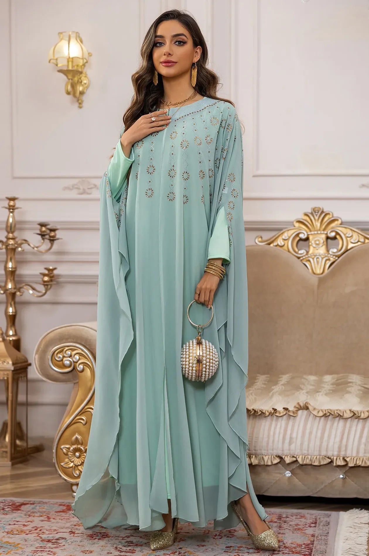 A sophisticated pose in the Light Green Cassia Rhinestone Kaftan, ideal for formal evening events.