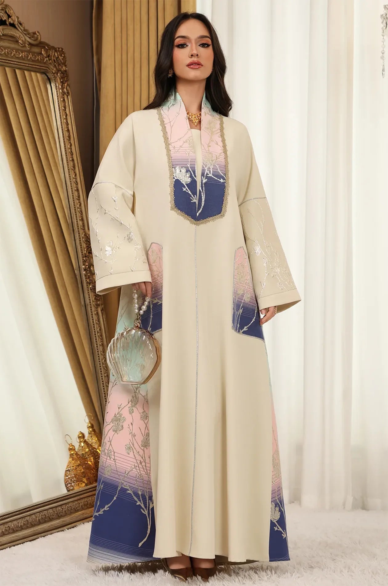 Model styled in the Liorra Dark Blue Kaftan Ombre holding a shell-shaped luxury clutch, perfect for formal party events.