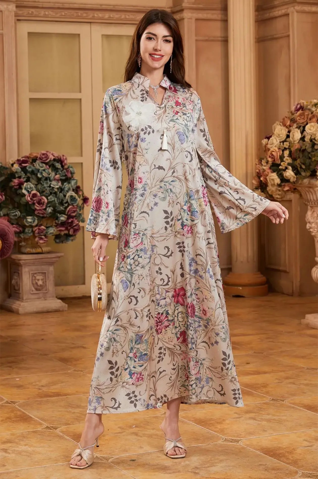 The Lyris satin kaftan maxi dress showing the elegant movement of the flared sleeves.