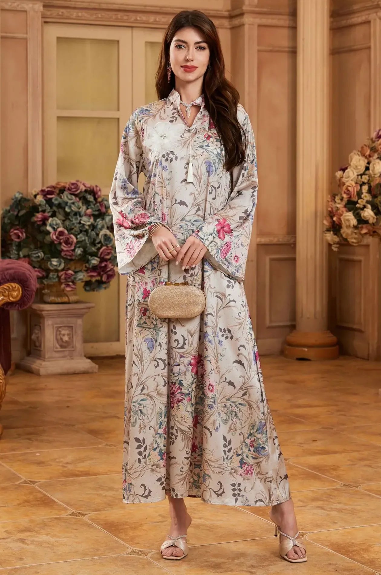 Styling inspiration for the Lyris floral kaftan paired with a gold evening clutch.