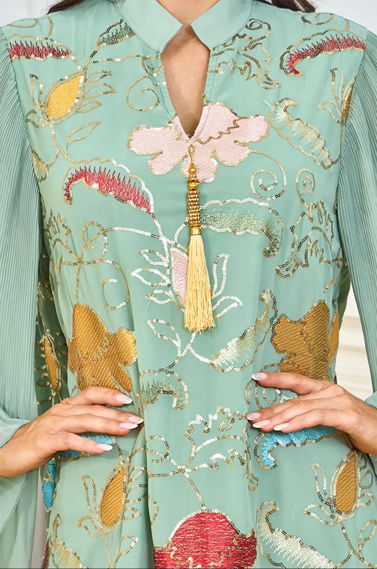 Detailed close-up of the Marylin Green Tassel Kaftan's bodice, showing the intricate gold and red floral sequin embroidery.