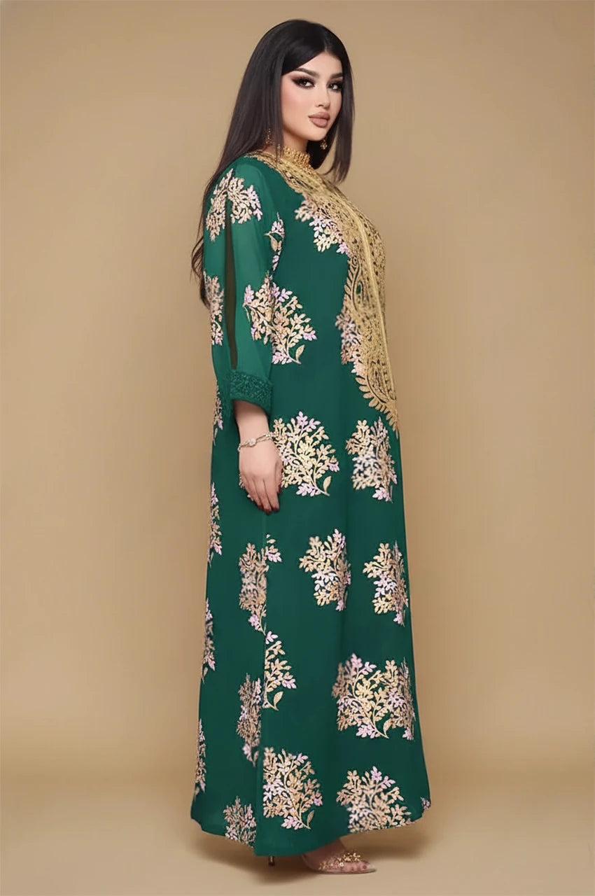 Side view of emerald green Mhaya feather sleeve kaftan showing relaxed straight silhouette and gold embroidery