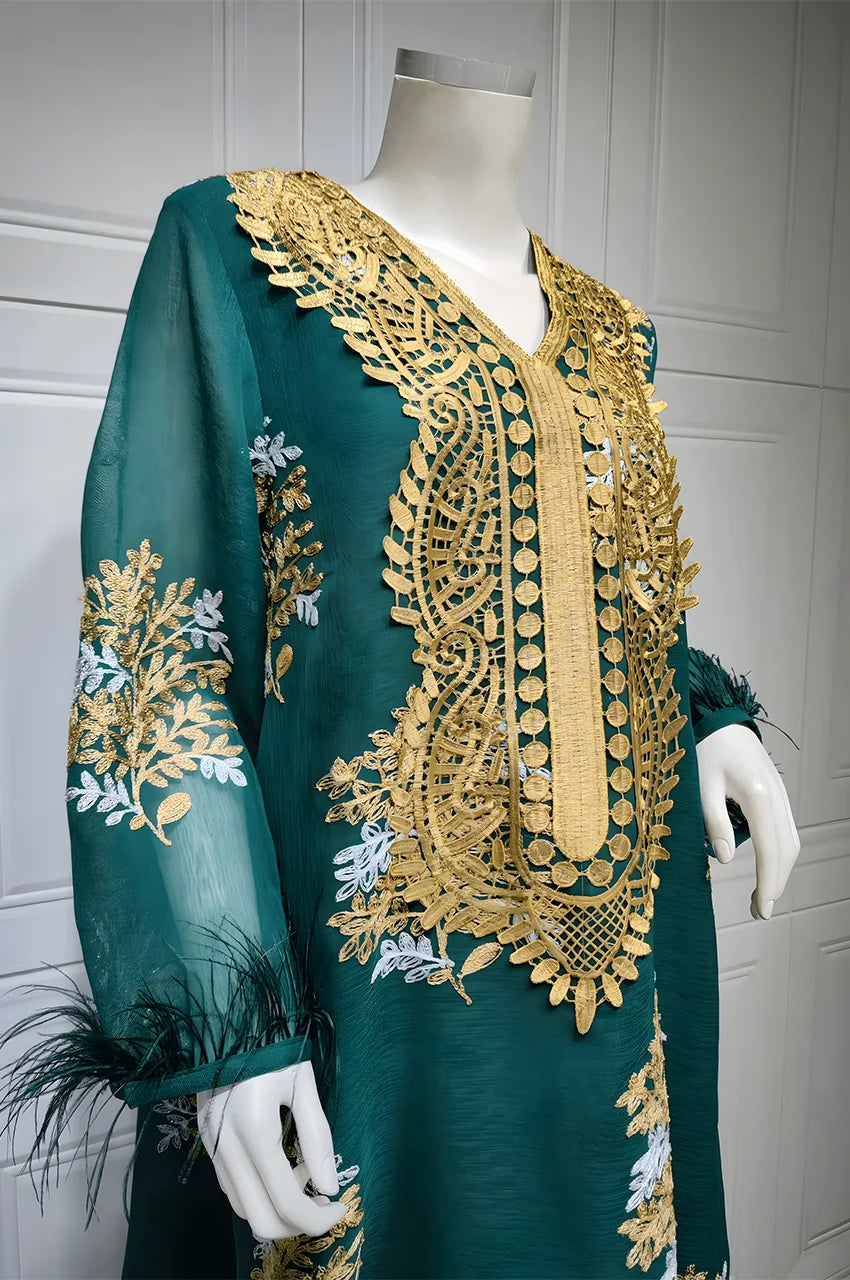 Detailed view of Mhaya kaftan neckline with intricate gold plastron embroidery and sheer sleeve.