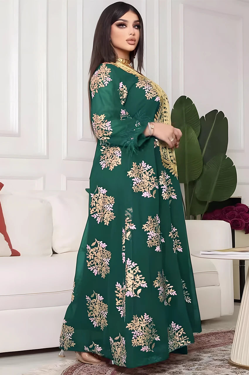 Side profile—Mhaya emerald feather-sleeve kaftan in a flowing maxi silhouette.