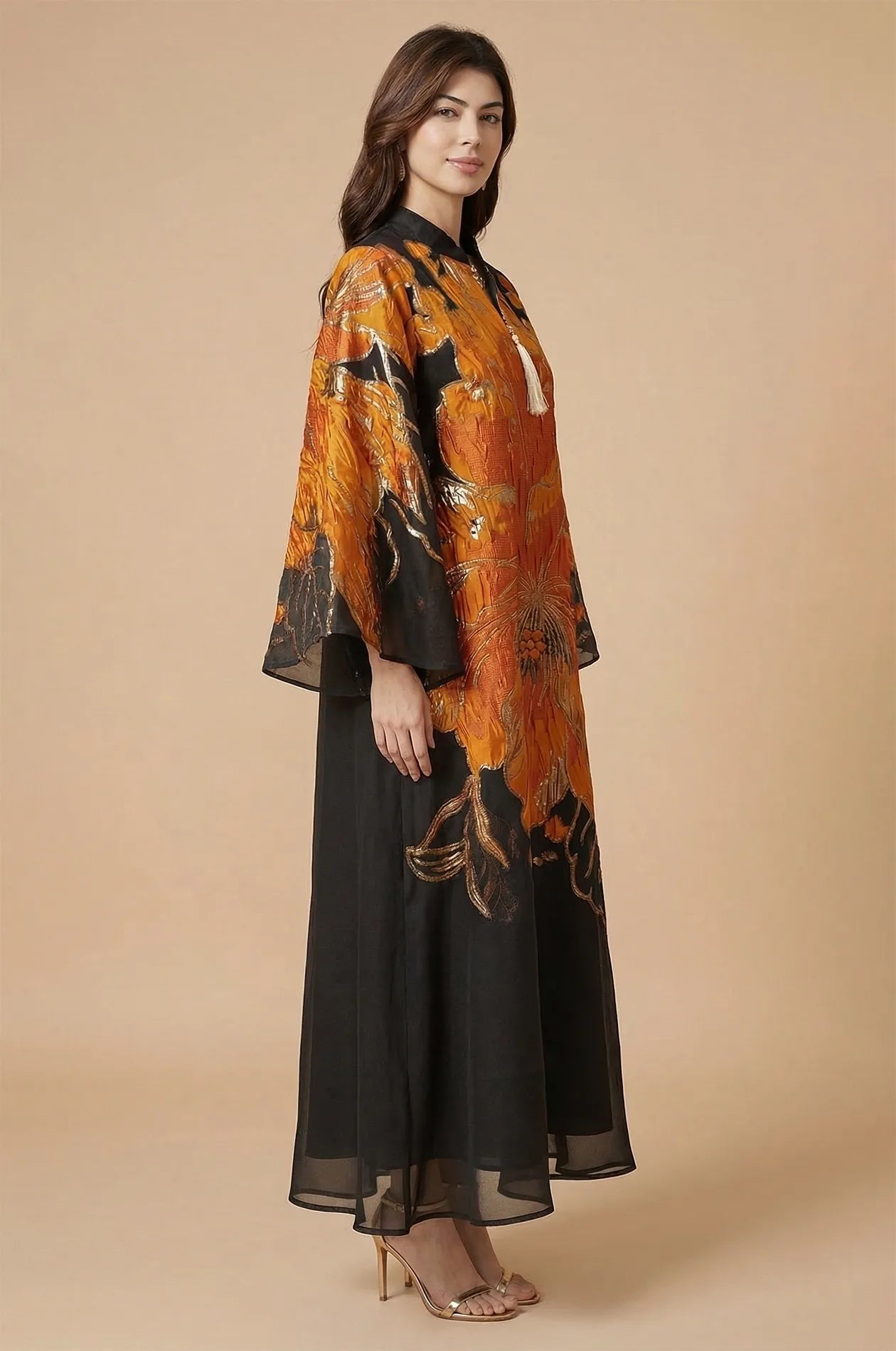 Side profile of the Naeli Orange Kaftan highlighting the voluminous butterfly sleeves and lightweight pleated texture.