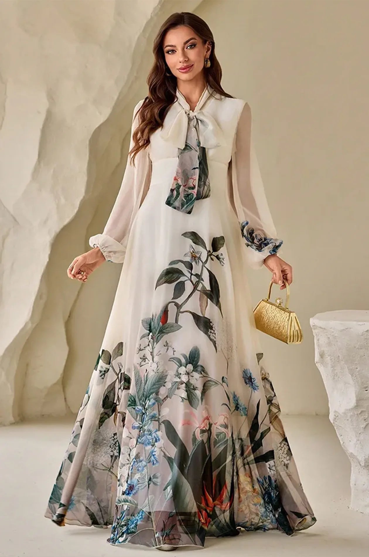 Arina floral kaftan styled with a gold clutch for a formal evening look.