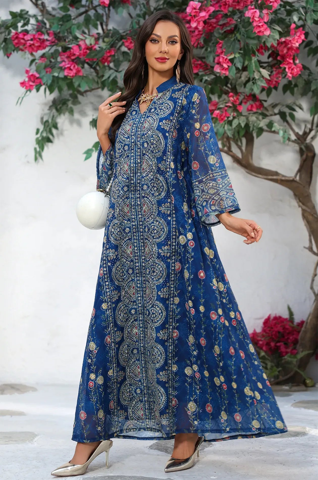 Elegant lifestyle pose in the navy Azari chiffon kaftan maxi dress illustrating the A-line silhouette and lightweight fabric.