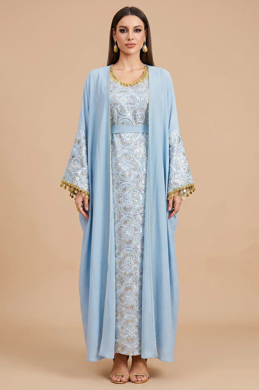 Full front view of the elegant sky blue Novae crepe kaftan from Naylara, featuring gold coin tassels.