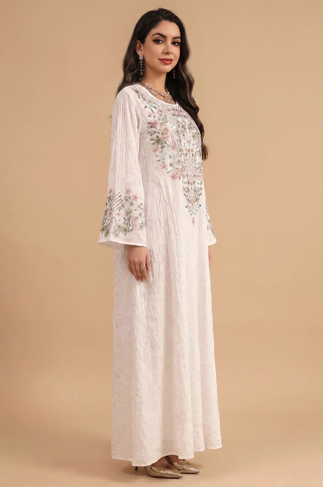 Side profile of the white Equis modest kaftan demonstrating the fluid movement of the flared sleeves.