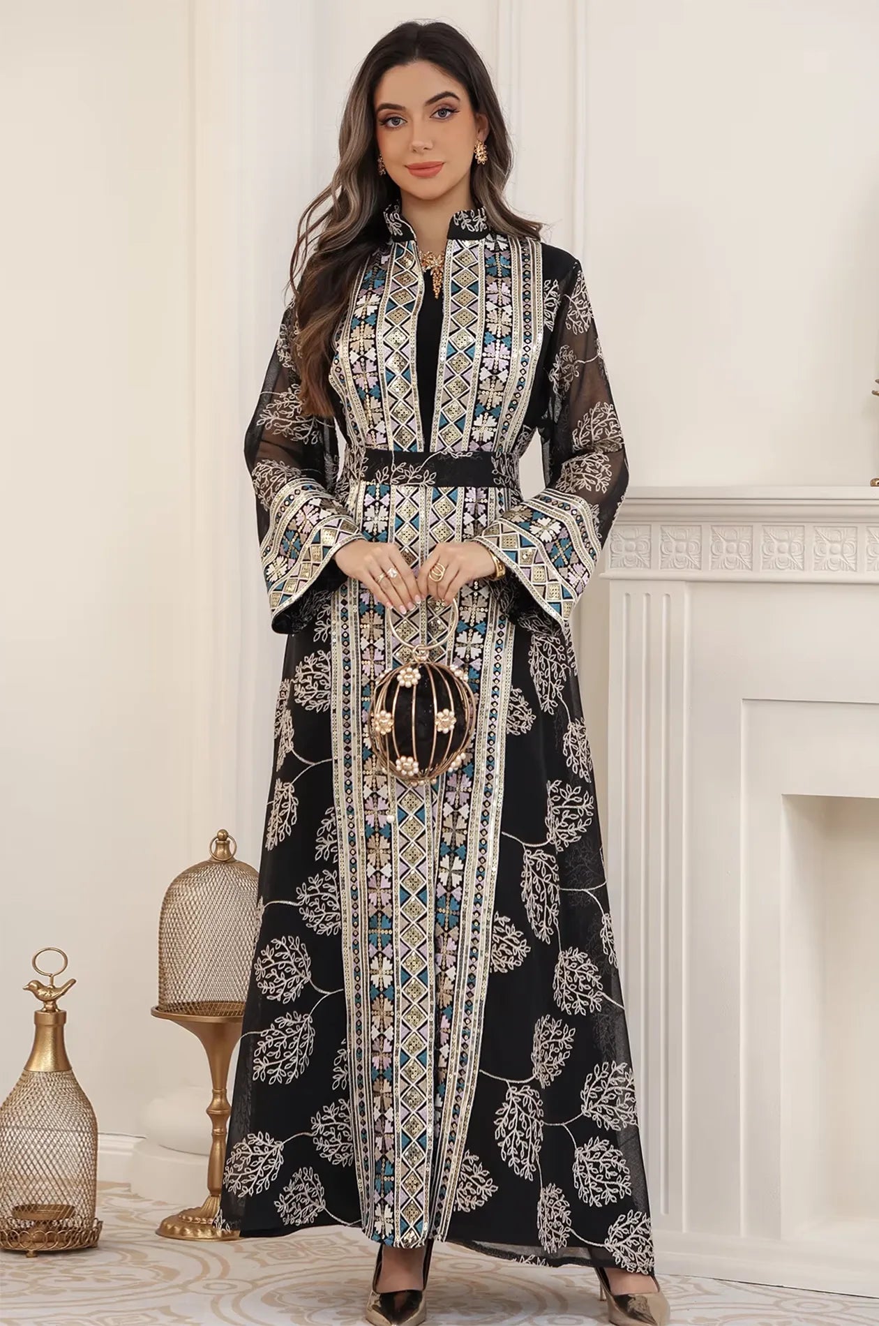 Elegant styling of the Gienah black chic kaftan paired with a pearl evening bag, perfect for a formal party or wedding.