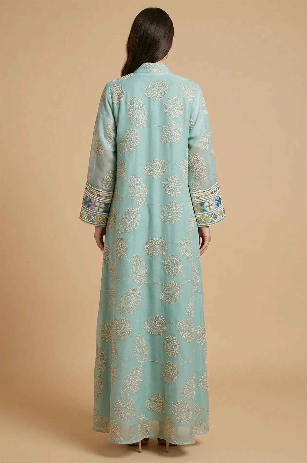 The elegant back view of the light green Gienah chic kaftan showcasing intricate silver-thread embroidery on sheer fabric.