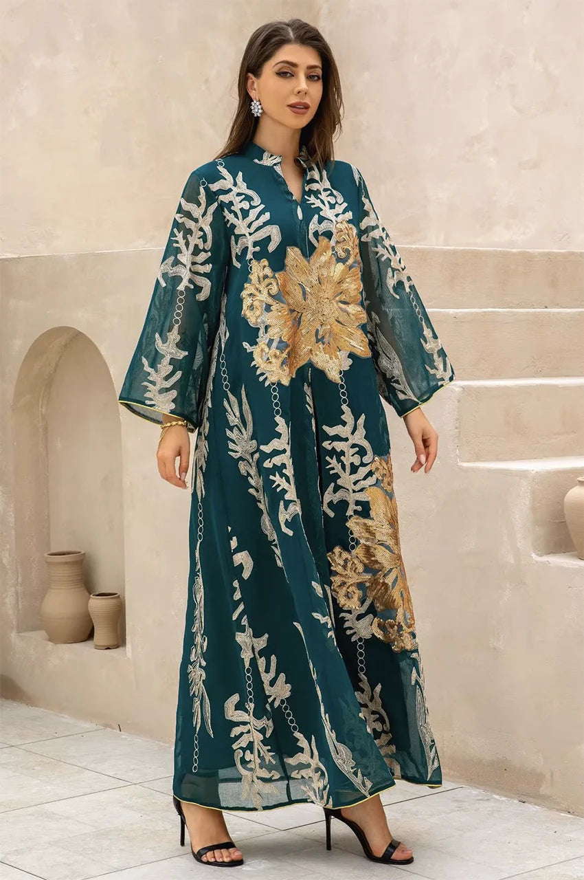 Full-length front shot of the emerald green Maliya flower kaftan against a minimalist Mediterranean-style background.