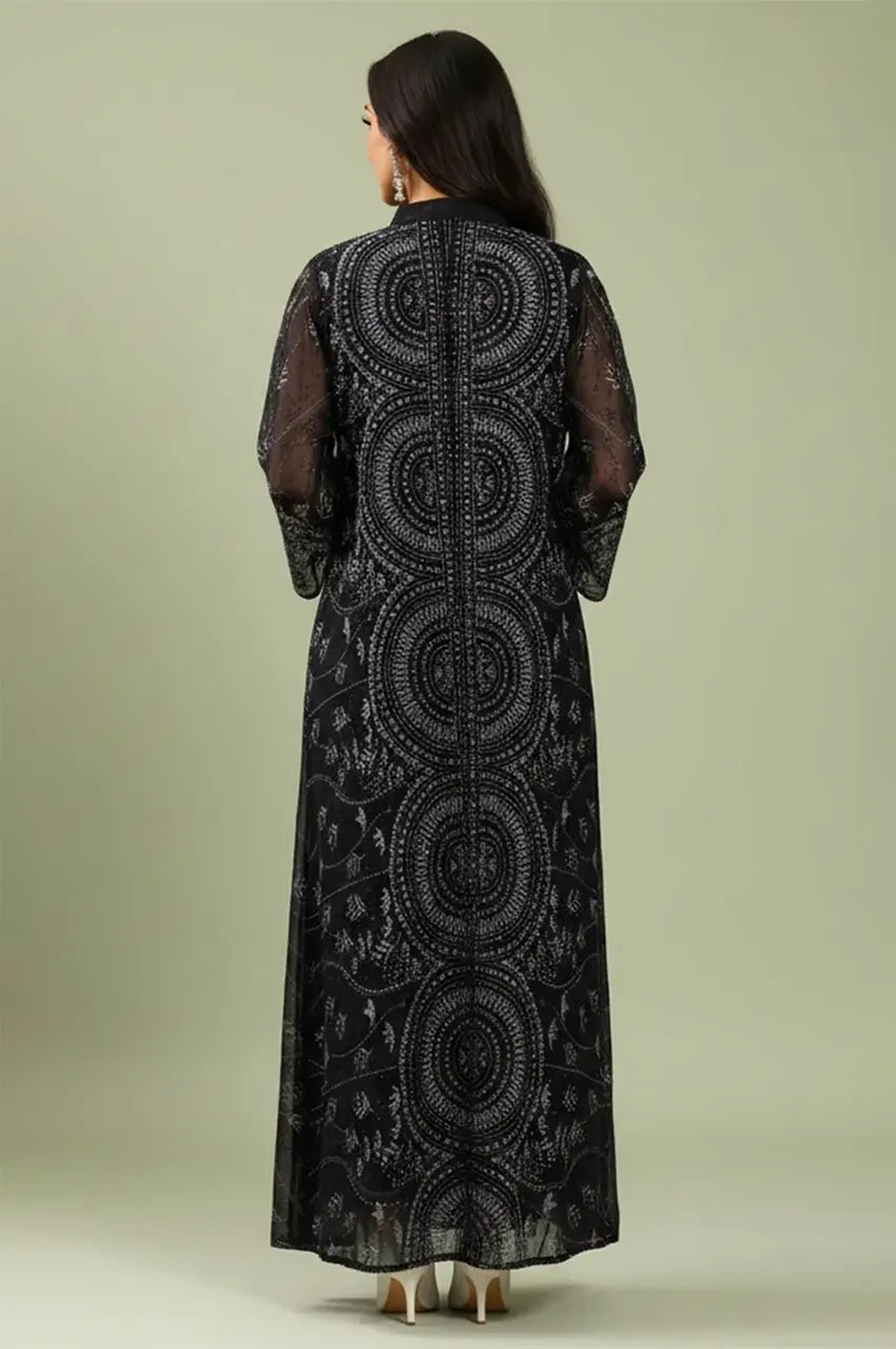 Rear view of the Kaly Black sheer maxi kaftan highlighting the continuous ornate circular embroidery patterns down the back.